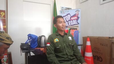 Suasana gerbang Wisata Mikutopia Kota Batu yang teduh dengan petugas ramah berjaga di pos kesehatan dan ambulans terparkir di samping.